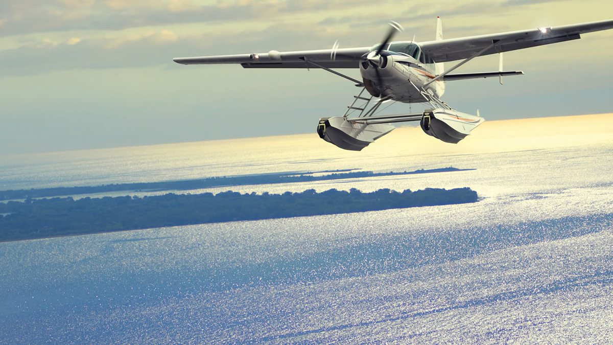 A seaplane flying low over the sparkling sea off Puerto Rico
